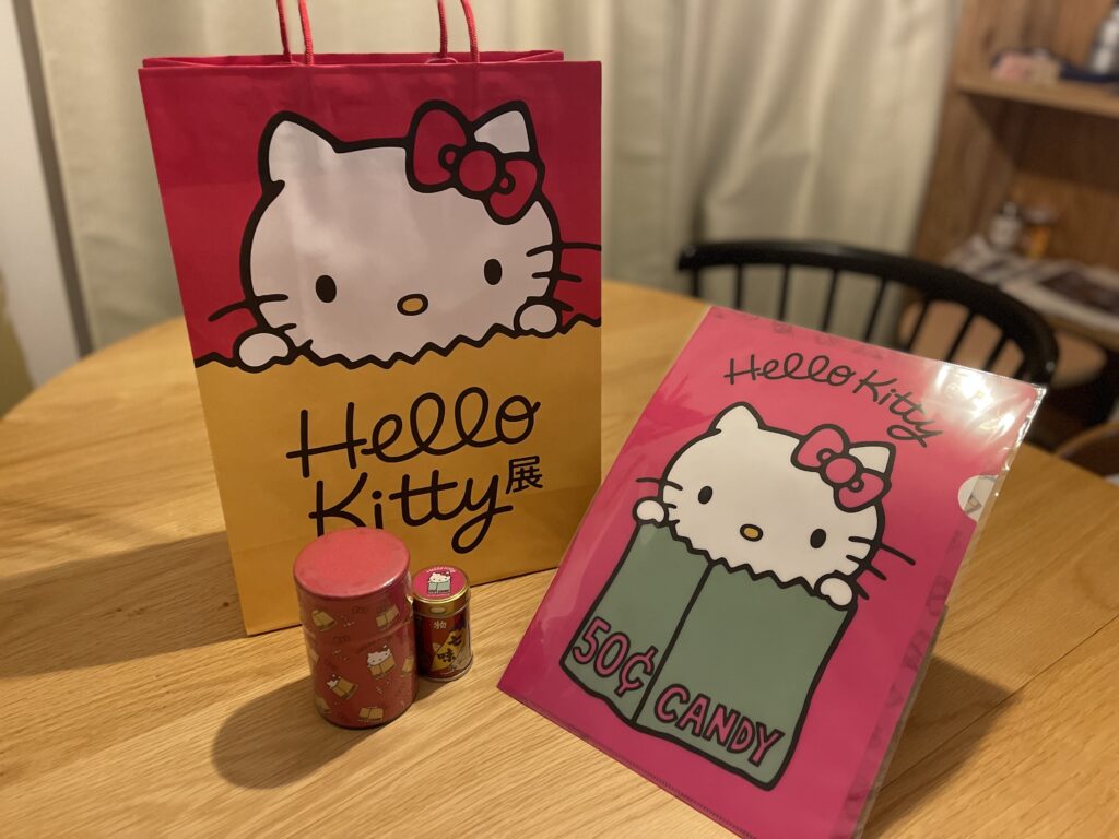 Hello Kitty展 京都限定グッズ。根元八幡屋礒五郎の七味唐からし、京都おふく園のほうじ茶缶、クリアファイルとショッパーのグループショット