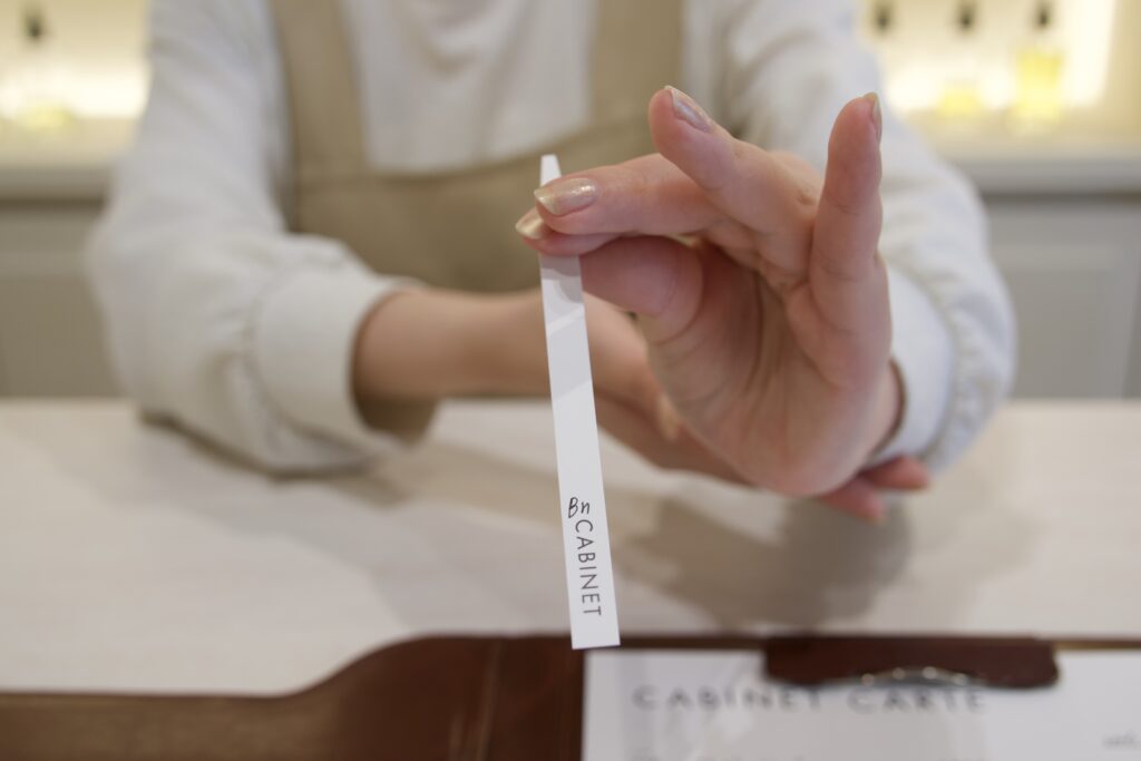 CABINET_調香師が試香紙を使って香料を紹介する様子